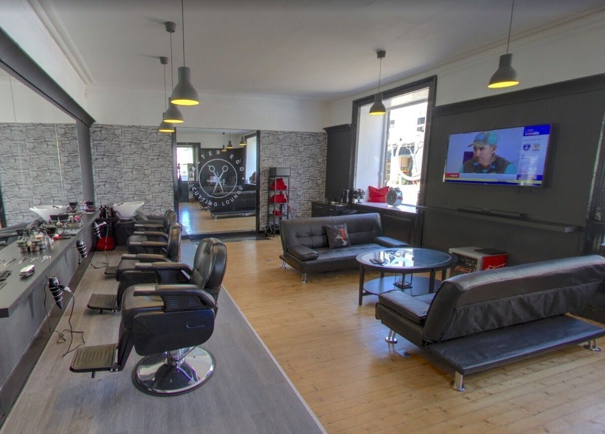 Spacious and modern interior of Alter Ego in Ayr, Scotland, GB featuring stylish salon and lounge area.