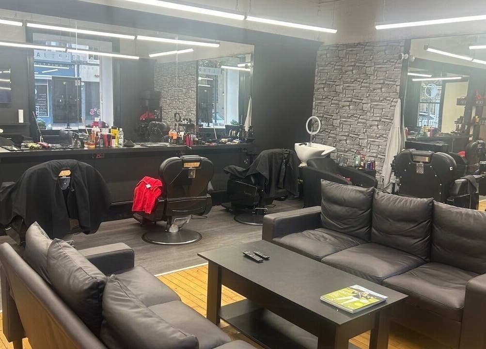 Interior of Alter Ego in Ayr, Scotland, GB showing modern black seating and styling stations.