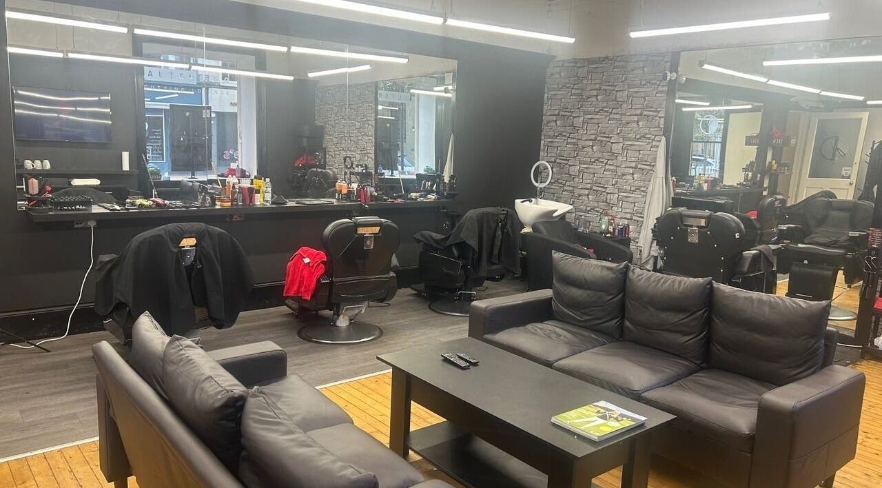 Interior of Alter Ego in Ayr, Scotland, GB showing modern black seating and styling stations.