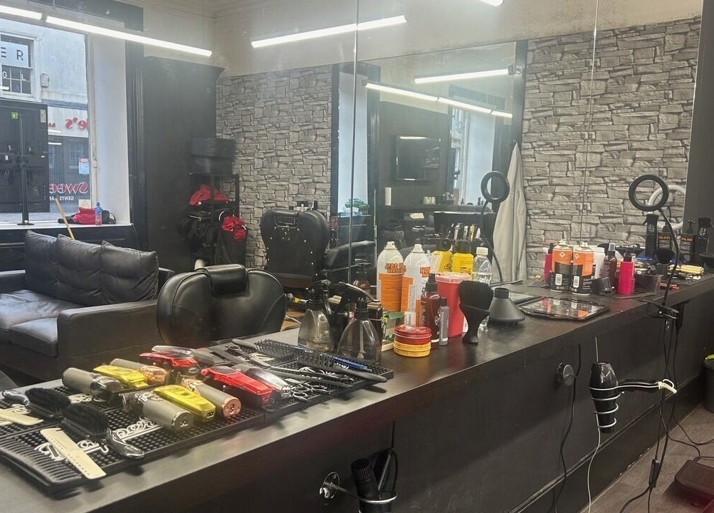 Modern hair salon interior at Alter Ego in Ayr, Scotland, GB, showcasing chic styling stations and cozy seating.