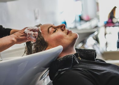 Client enjoys a soothing hair wash at Salon White Blue in Edmonton, Alberta, CA.