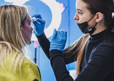 Beauty professional applying treatment at Salon White Blue, Edmonton, Alberta, CA.