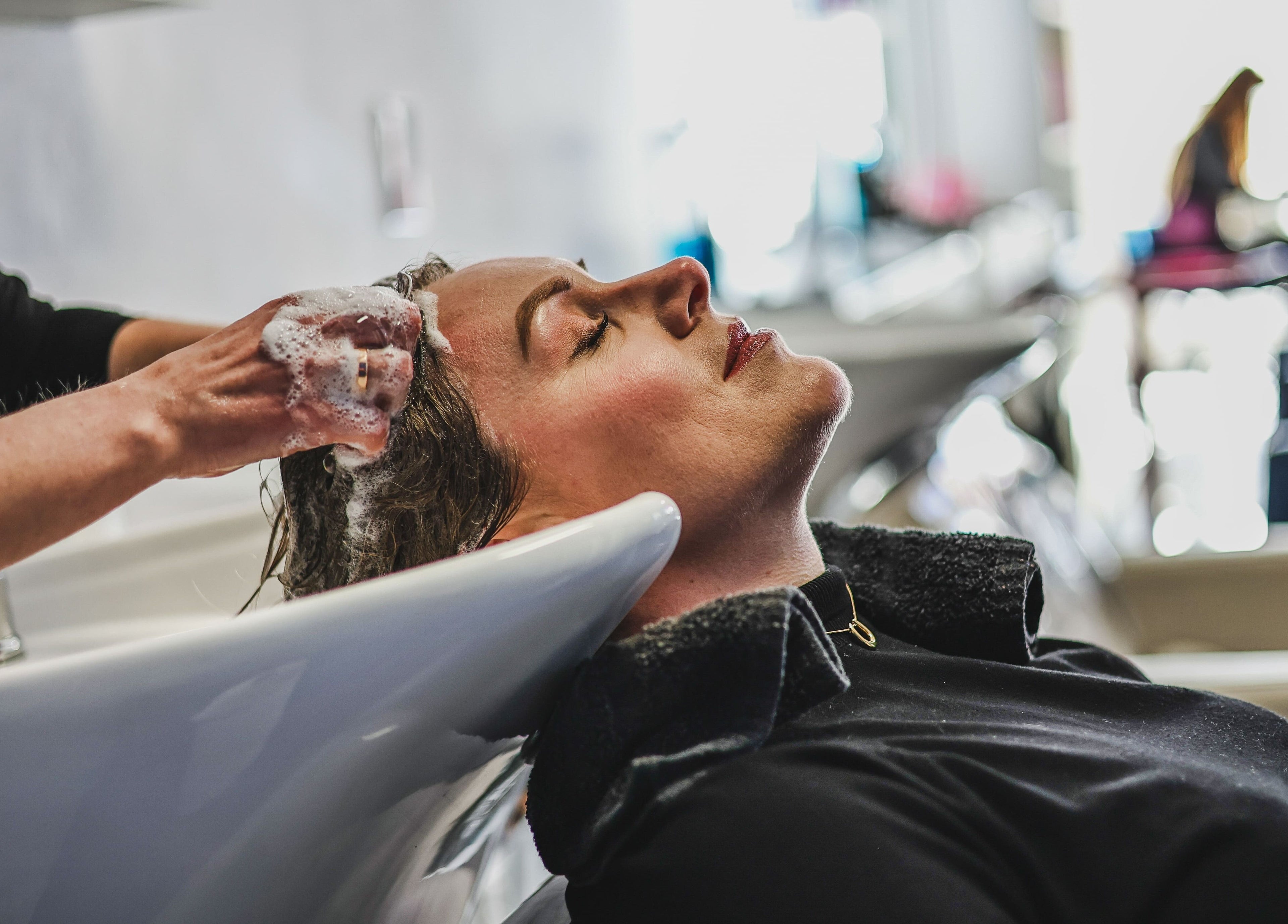 Relaxing hair wash at Salon White Blue in Edmonton, Alberta, CA, showcasing luxurious customer care.