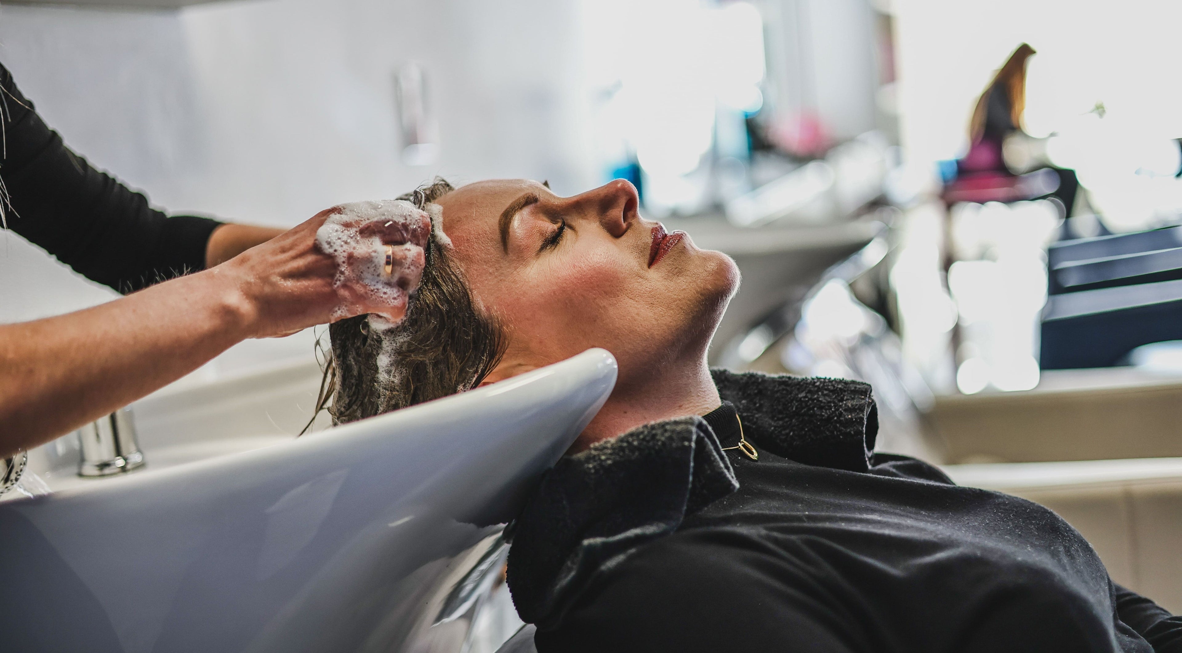 Relaxing hair wash at Salon White Blue in Edmonton, Alberta, CA, showcasing luxurious customer care.