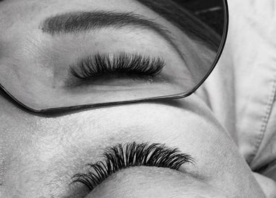 Close-up of eyelash extensions at Lashiez, Pretoria, Gauteng, ZA, reflected in a circular mirror.