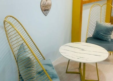 Chic seating area at Pixi Dust, Kuala Lumpur, featuring stylish chairs and a marble-top table.