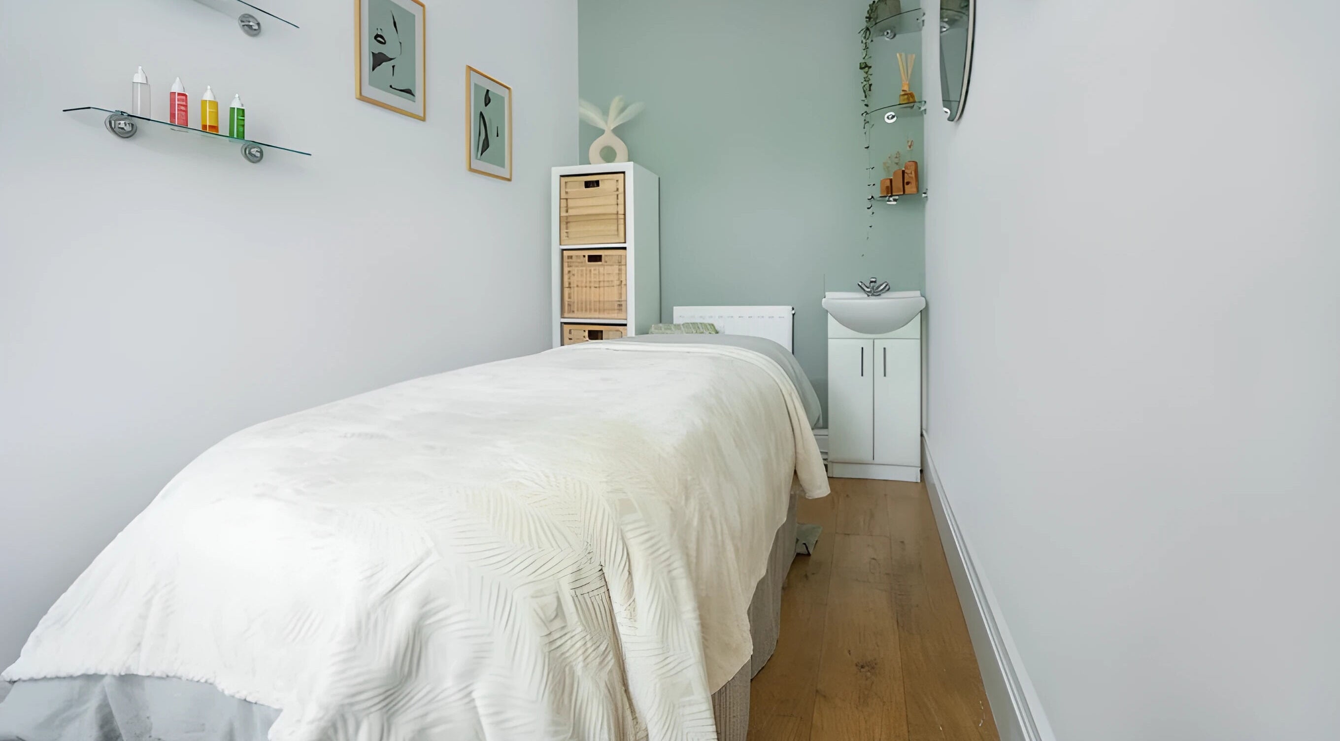 Tranquil massage room at Sage Massage, Wilmslow, England, GB, showcasing a cozy bed and calming decor.