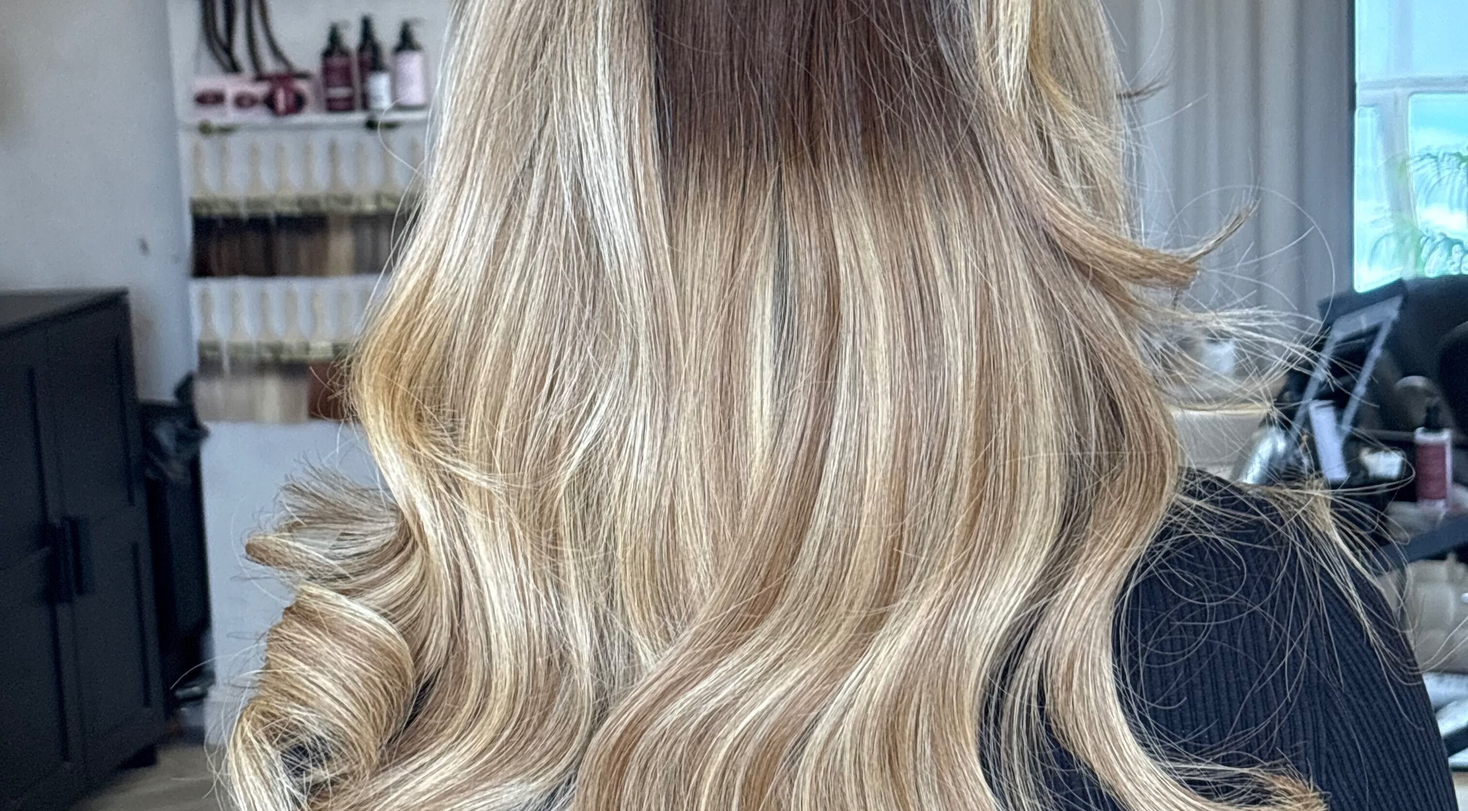 Blonde hair styled into soft waves at D.Alexander Hair in Watford, England, GB.