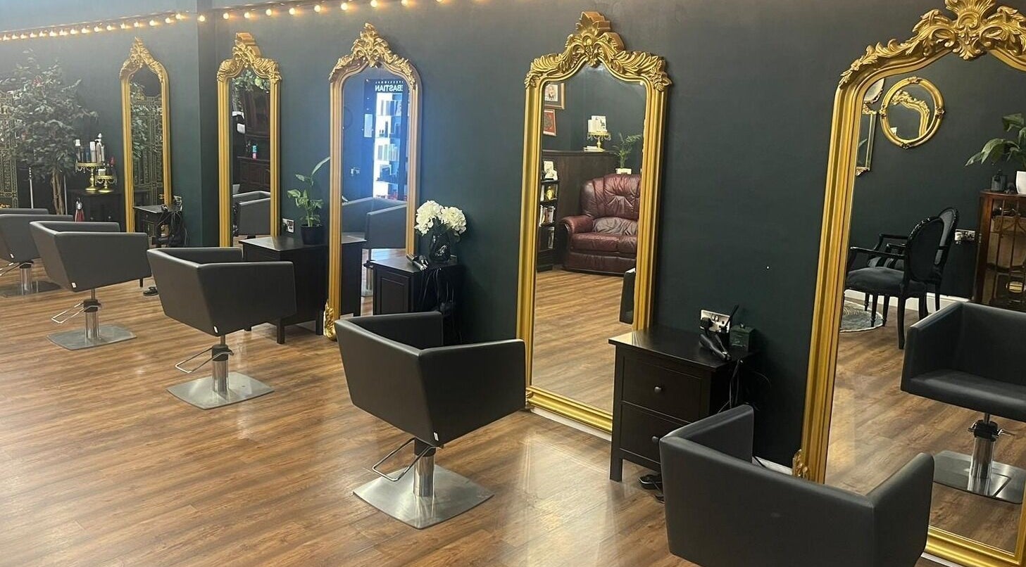 Elegant styling chairs and gilded mirrors at Another Dimension Hair Emporium, Barnsley, England, GB.