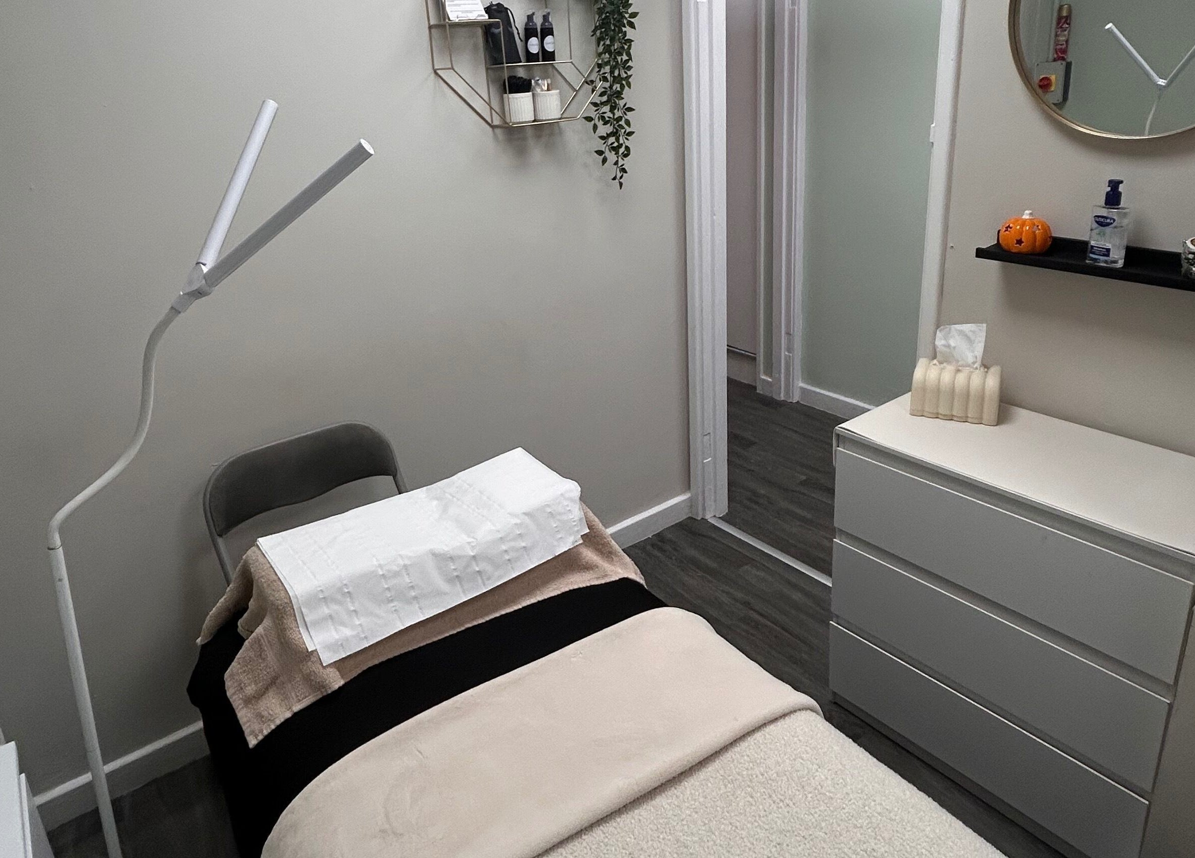 Cozy treatment room at Lashes and Brows by Georgia, Stoke-on-Trent, England, with bed and modern decor.