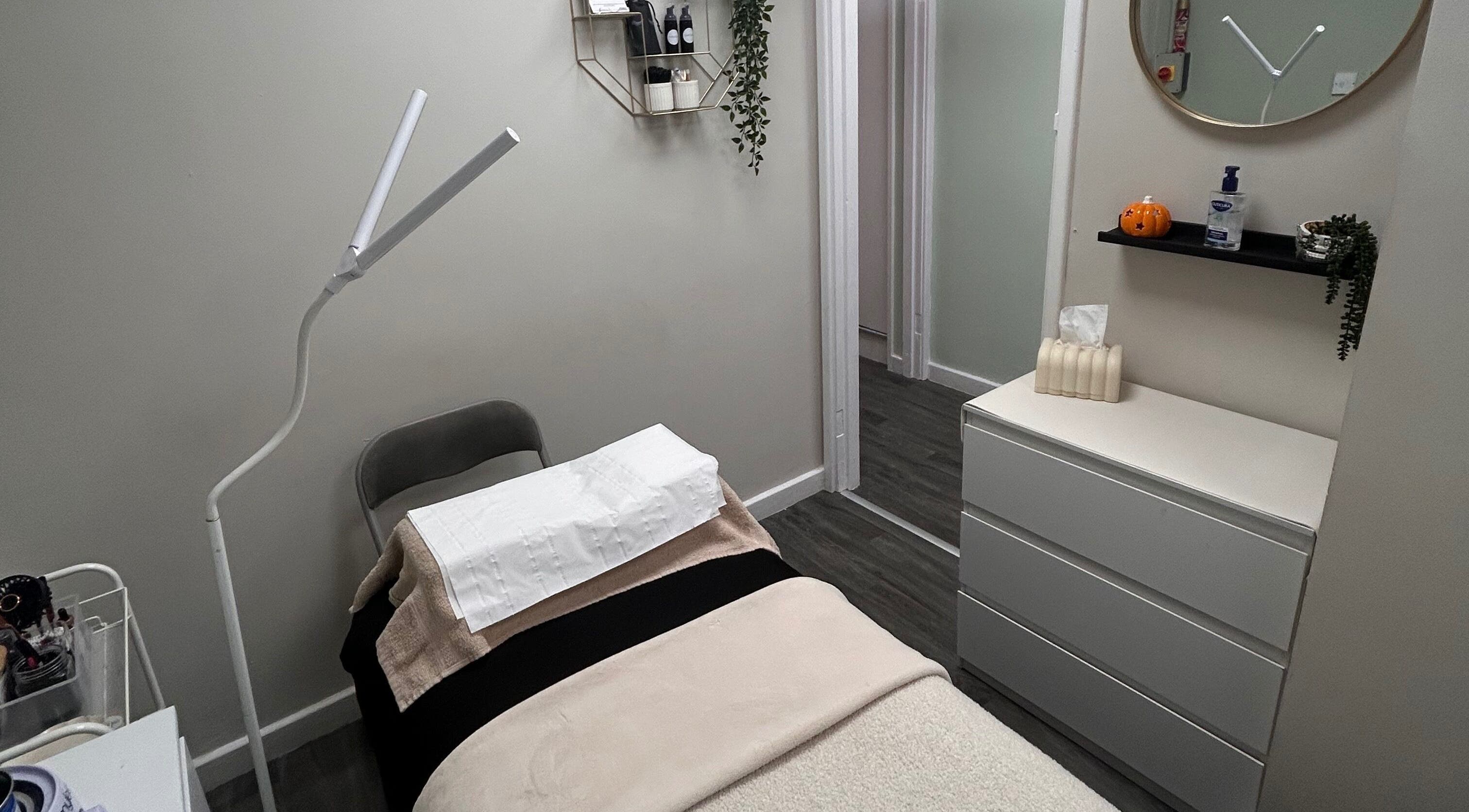 Cozy treatment room at Lashes and Brows by Georgia, Stoke-on-Trent, England, with bed and modern decor.
