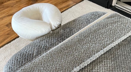Comfortable massage setup at Waseley Wellbeing in Worcestershire, GB, featuring a plush headrest and soft mats.