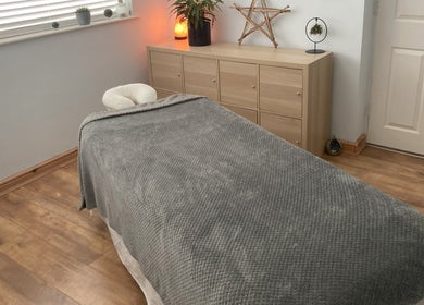 Cozy massage room at Waseley Wellbeing, Worcestershire, GB, with a soothing ambiance and decor.