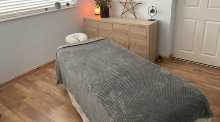 Cozy massage room at Waseley Wellbeing, Worcestershire, GB, with a soothing ambiance and decor.