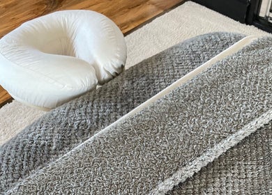Comfortable massage area with soft rugs at Waseley Wellbeing, Worcestershire, GB.