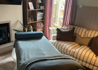 Cozy massage room with fireplace at Waseley Wellbeing, Worcestershire, GB, offering tranquil relaxation.