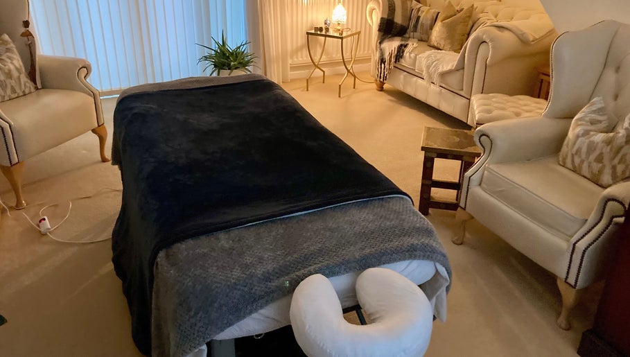 Relaxing massage room at Waseley Wellbeing, Worcestershire, GB, featuring a plush massage table and elegant décor.