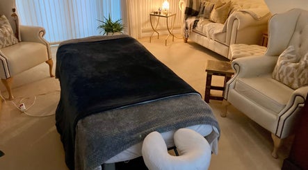 Relaxing massage room at Waseley Wellbeing, Worcestershire, GB, featuring a plush massage table and elegant décor.