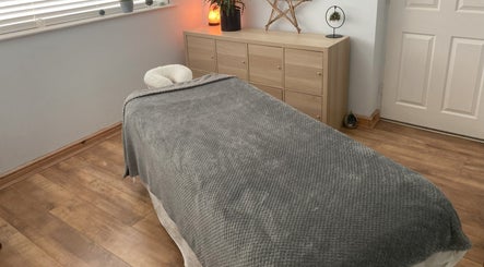 Relaxing spa room at Waseley Wellbeing in Worcestershire, GB with a cozy massage table.