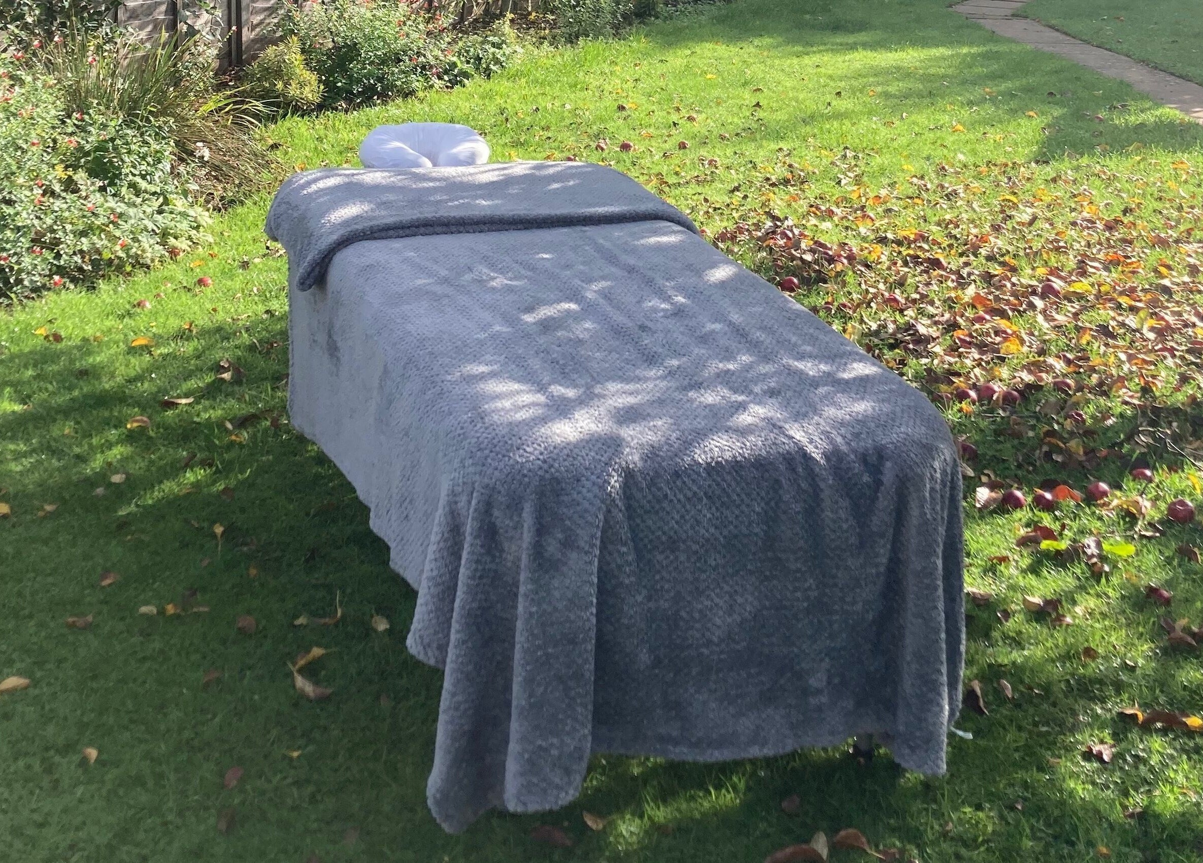 Outdoor massage bed at Waseley Wellbeing, Worcestershire, GB offering a serene relaxation spot.