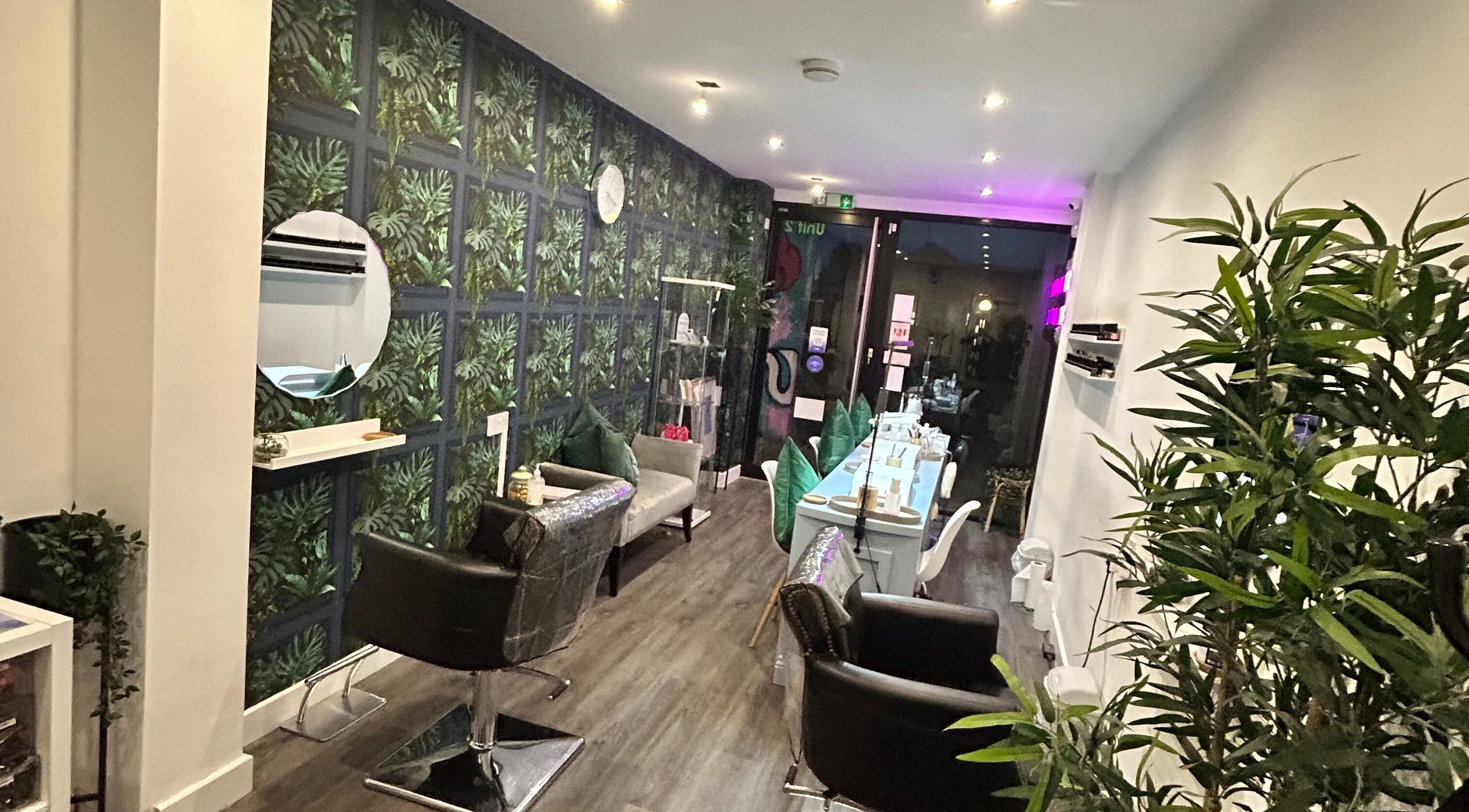 Inside Empire Beauty in Sheffield, England, GB, featuring chic decor, styling stations, and vibrant greenery.