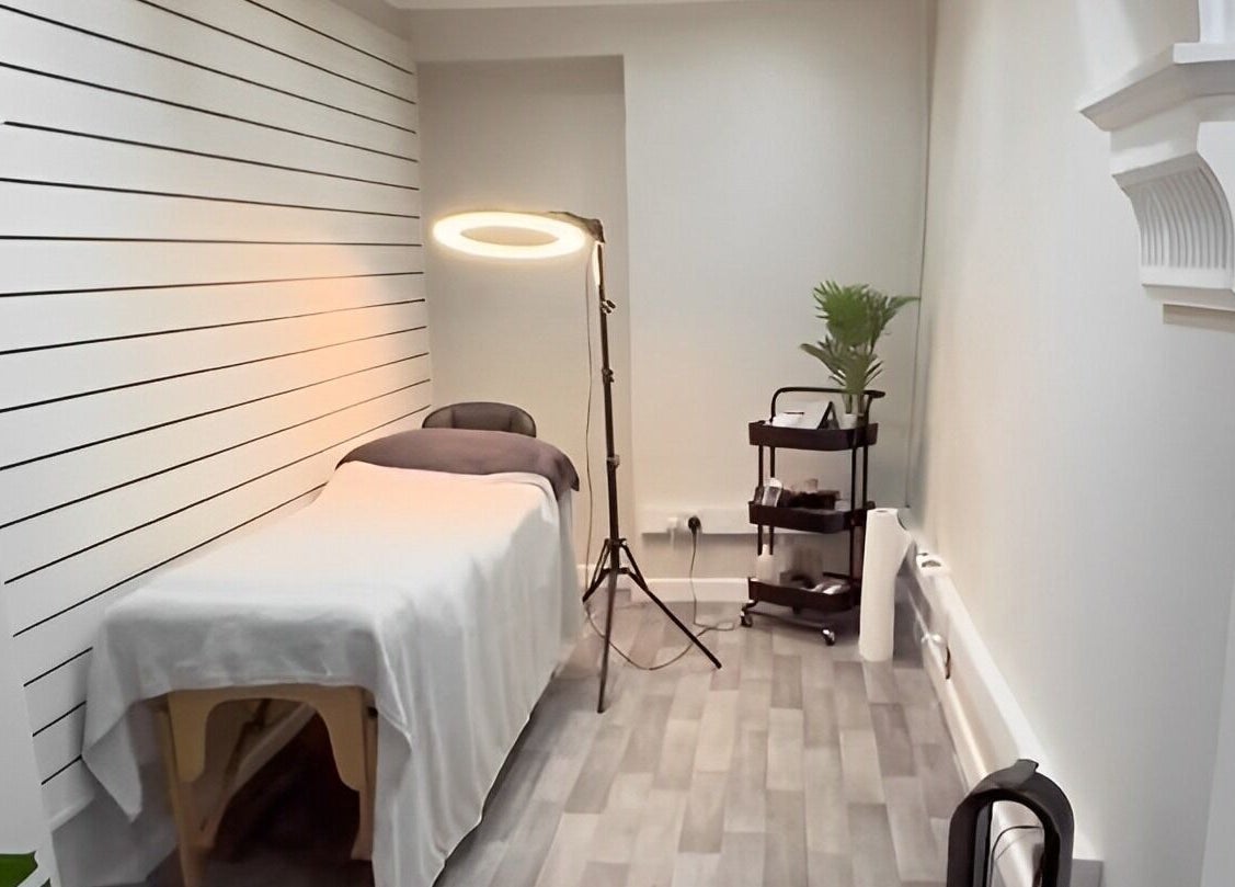 Elegantly designed beauty room at Ekb Studio, Lydney, England, GB, featuring a massage bed and cozy ambient lighting.