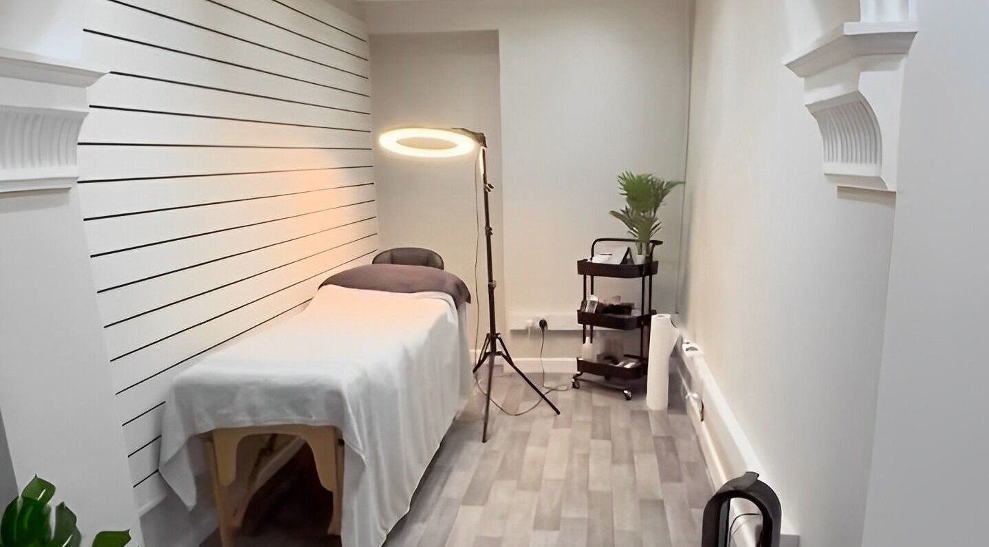 Elegantly designed beauty room at Ekb Studio, Lydney, England, GB, featuring a massage bed and cozy ambient lighting.