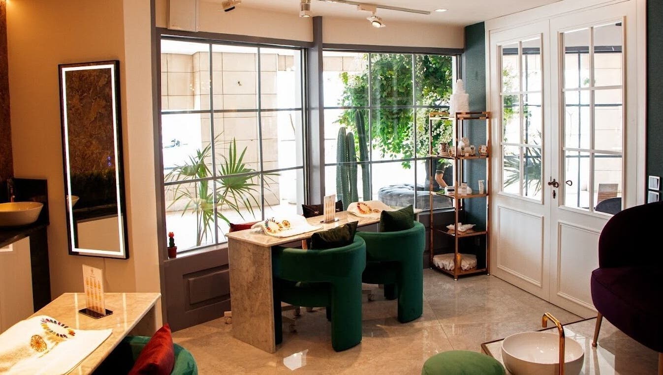 Elegant interior of Therapie Medspa, Lagos, with chic seating and greenery enhancing a soothing ambiance.