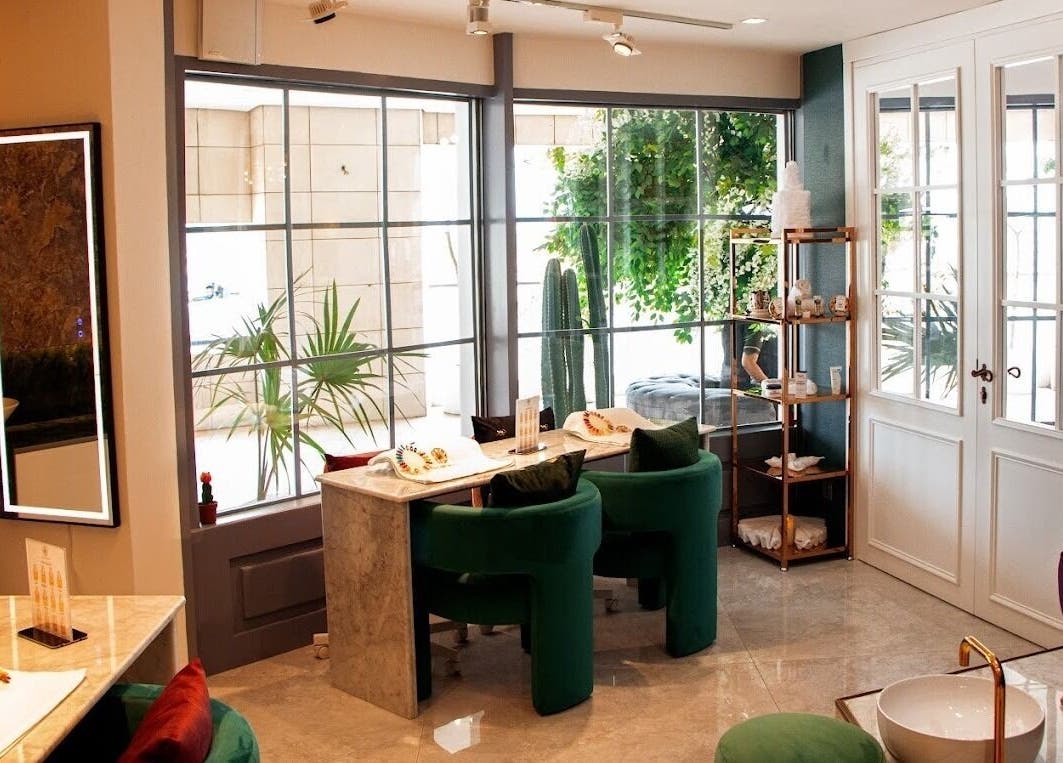 Elegant interior of Therapie Medspa, Lagos, with chic seating and greenery enhancing a soothing ambiance.