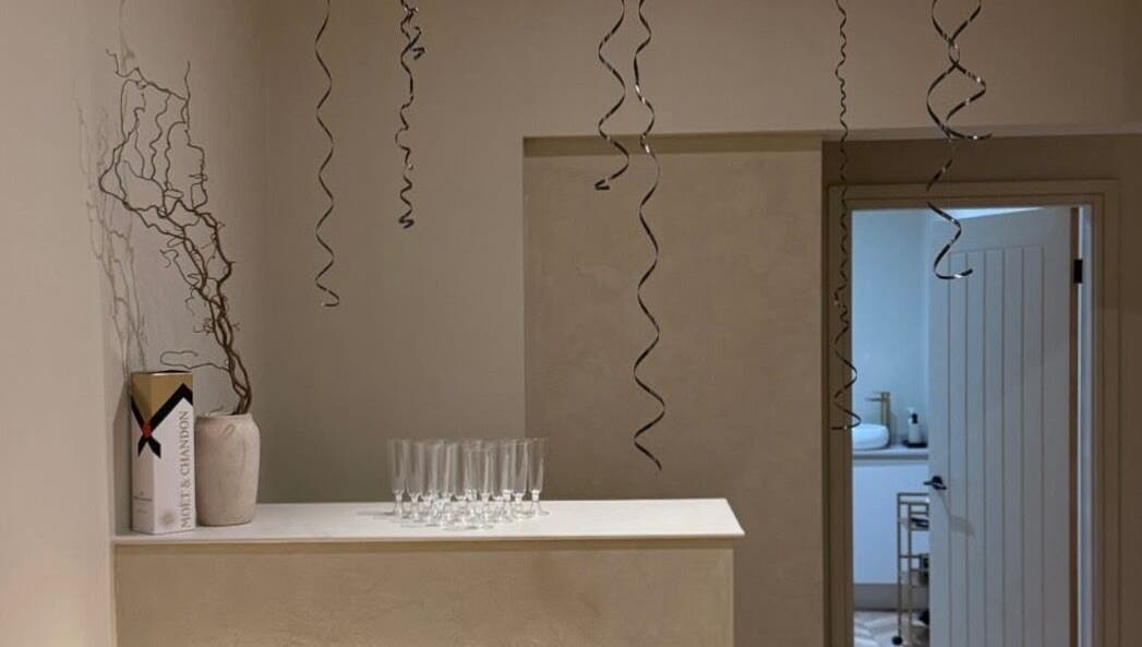 Chic decor with champagne box and glasses at TATTOOBAE, Bury, England, GB. Perfect for beauty and wellness ambience.