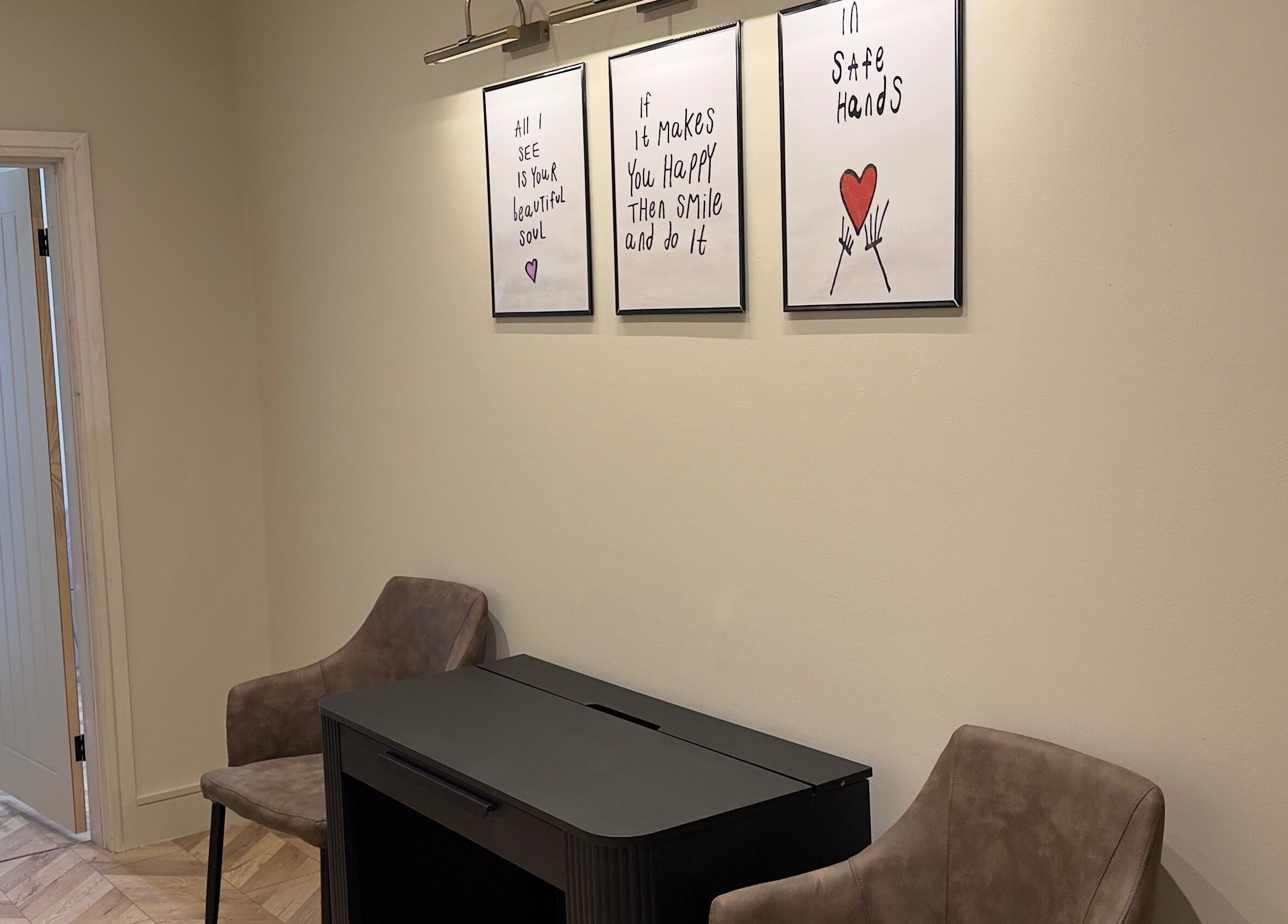 Cozy seating at TATTOOBAE with uplifting art prints in Bury, England, GB.