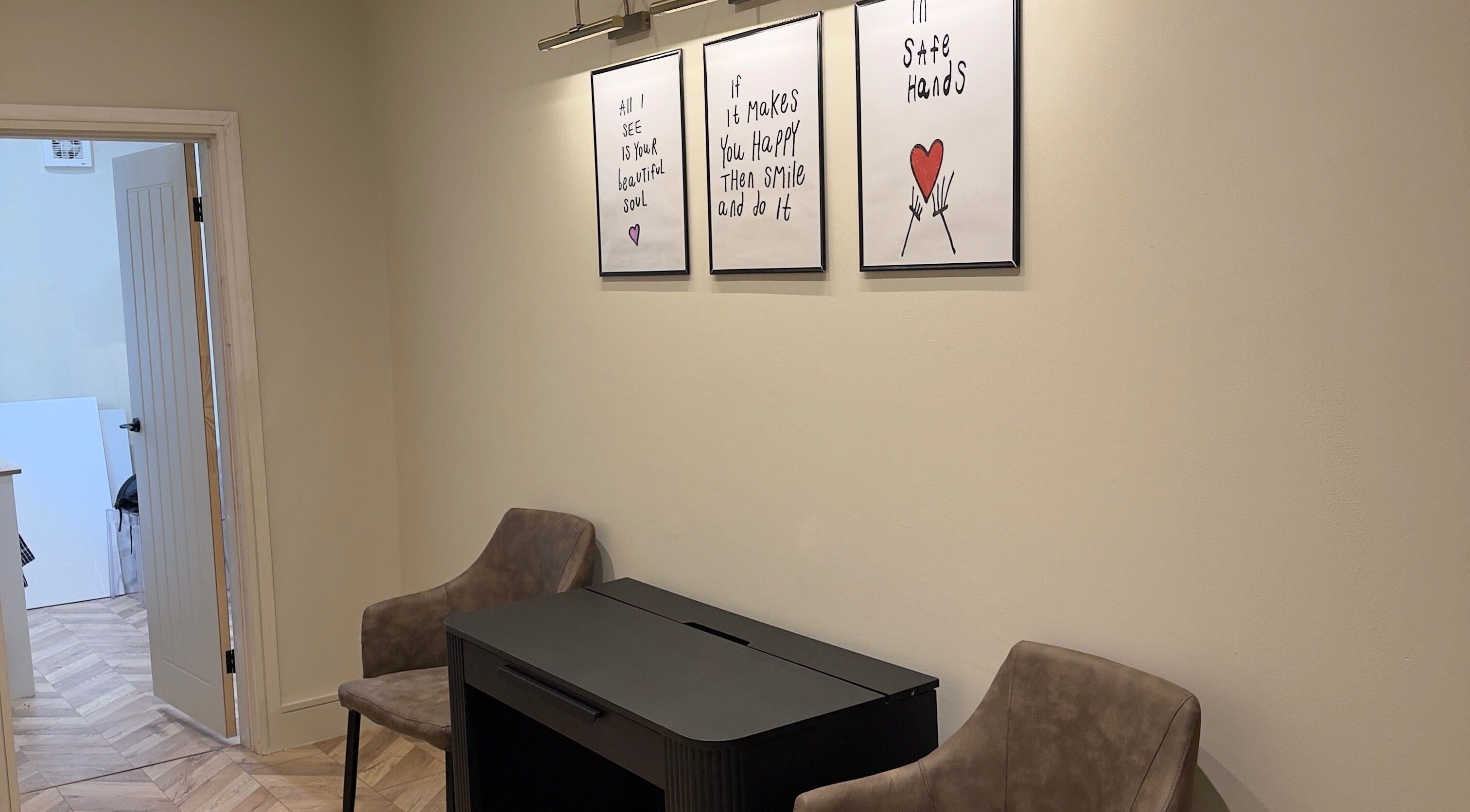 Cozy seating at TATTOOBAE with uplifting art prints in Bury, England, GB.