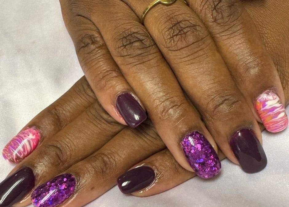 Stylish nail art at Cat's Claw Nails in Pretoria, Gauteng, ZA featuring dark and colorful designs.