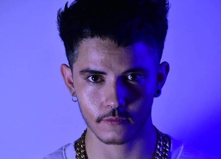 Stylish man at Mercuri Experience in Berlin, Berlin, DE, illuminated by vibrant blue lighting.