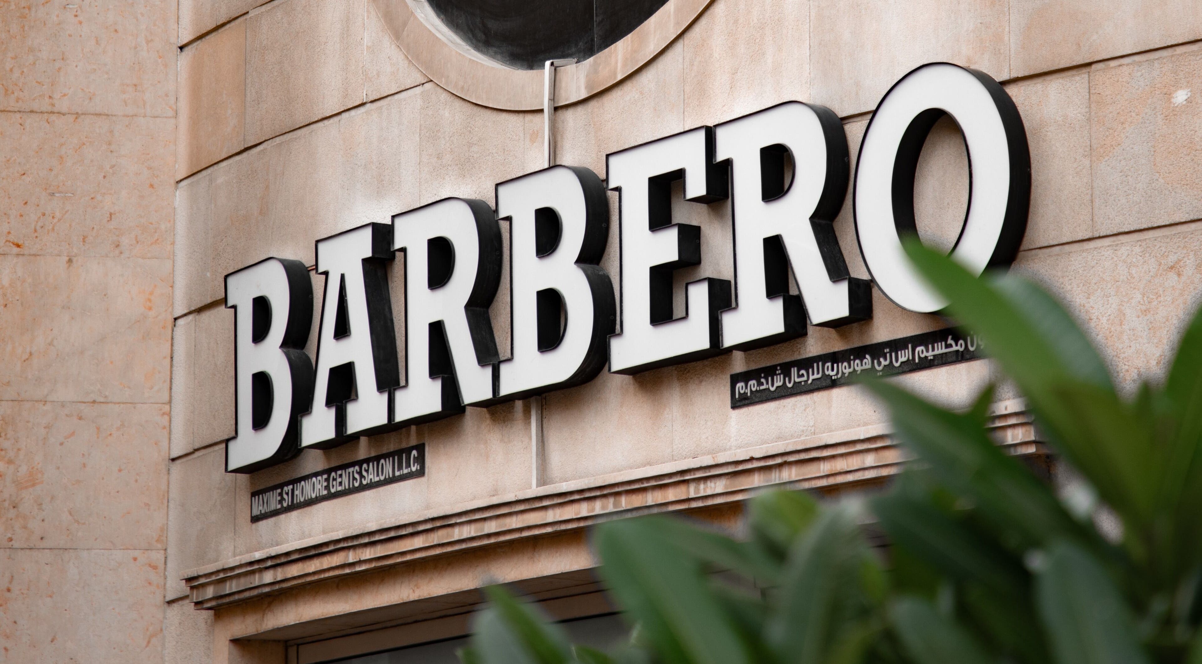 Signage of Barbero Gentlemen's Lounge in Dubai, AE displayed on a stylish exterior wall.