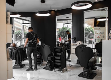 Interior of Barbero Gentlemen's Lounge, Dubai, AE showing modern barber chairs and sleek design.