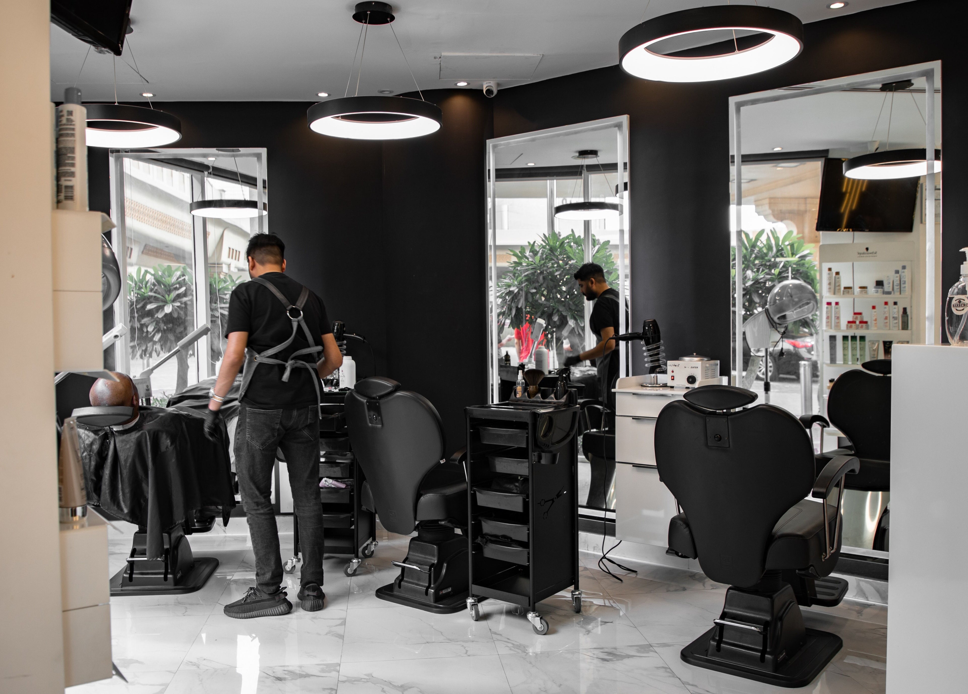 Interior of Barbero Gentlemen's Lounge, Dubai, AE showing modern barber chairs and sleek design.