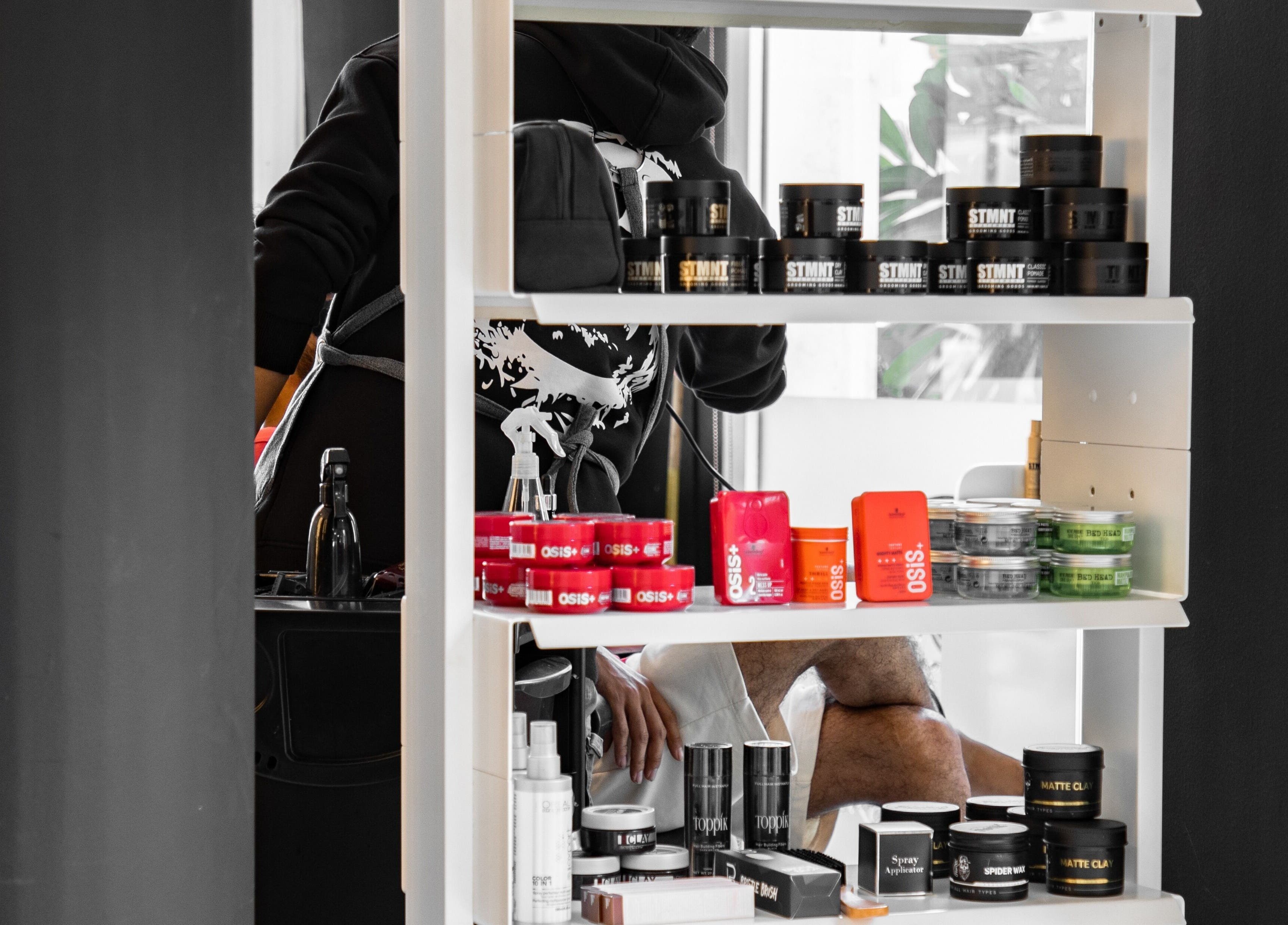 Shelf with grooming products at Barbero Gentlemen's Lounge, Dubai, AE.