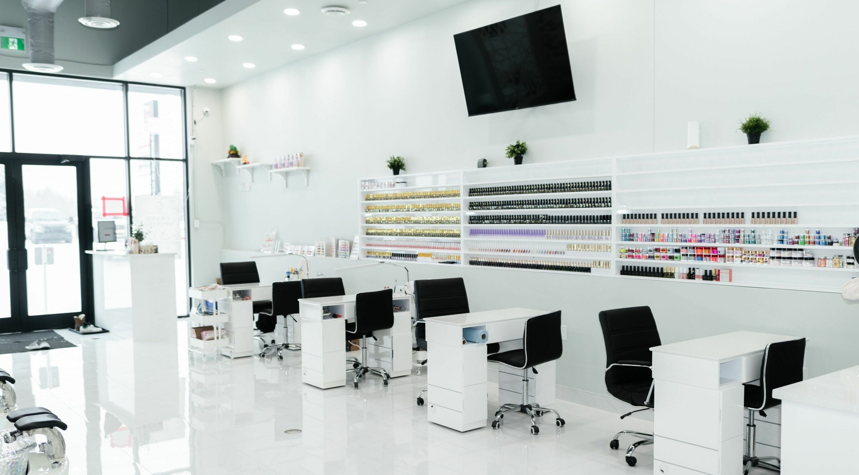 Bright interior of Mya Nails Studio in Edmonton, Alberta, CA showcasing stylish nail desks and polish displays.