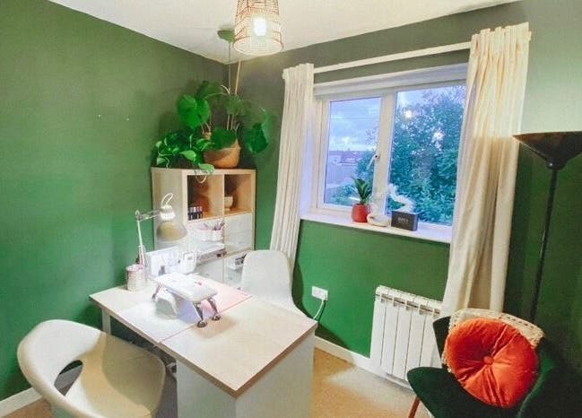 Cozy interior of Polished by Victoria in Redruth, England, GB with green walls and a stylish manicure station.
