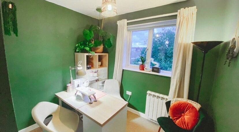 Cozy interior of Polished by Victoria in Redruth, England, GB with green walls and a stylish manicure station.