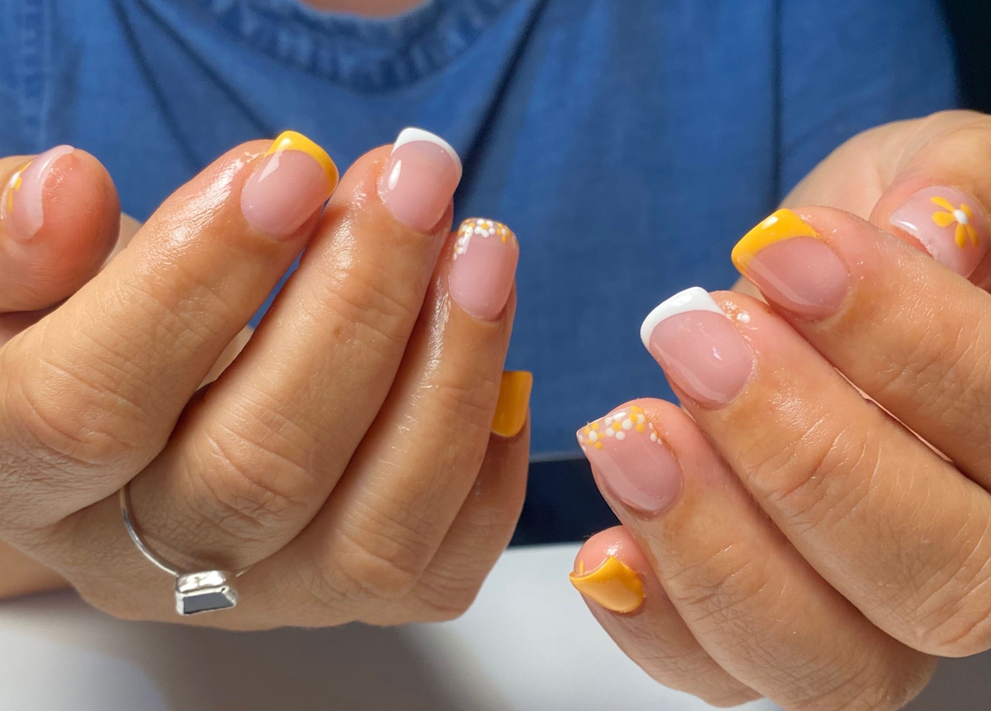 Stylish yellow and white nail art at Polished by Victoria in Redruth, England, GB.
