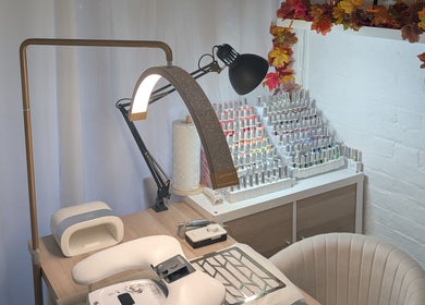 Nail station at Luxe Beauty by Rosie, Lowestoft, England, GB with nail polish display and equipment.
