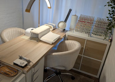Chic nail salon setup at Luxe Beauty by Rosie, Lowestoft, England, GB with cozy chairs and nail polish display.