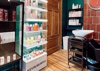 Tresor Beauty in Rīga, LV featuring sleek hair product displays and modern wash station.