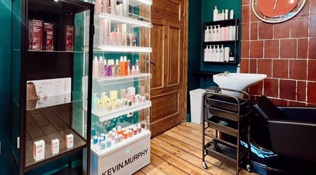 Tresor Beauty in Rīga, LV featuring sleek hair product displays and modern wash station.
