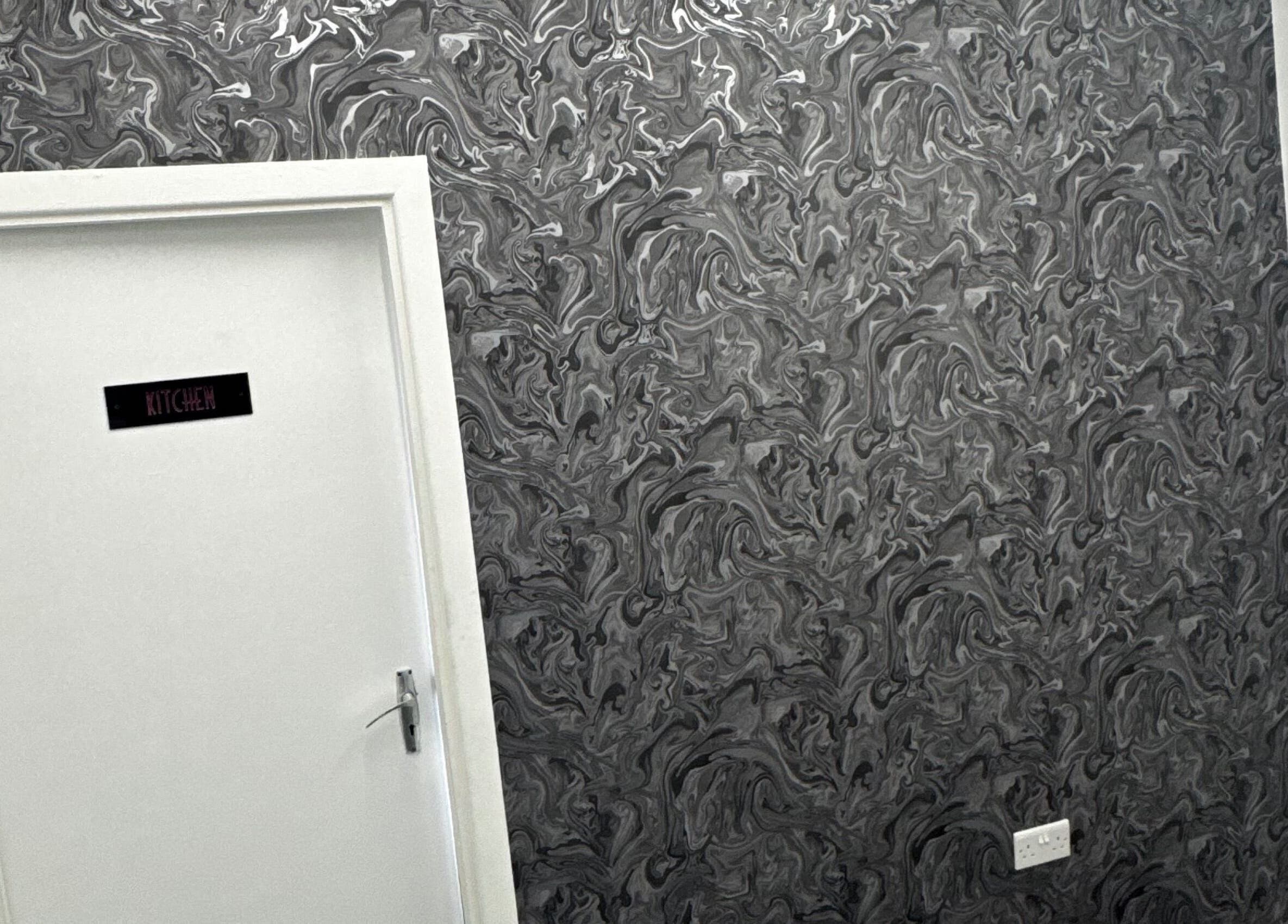 Stylish door with artistic wallpaper at Beautesuite By Erin, Dukinfield, England, GB.