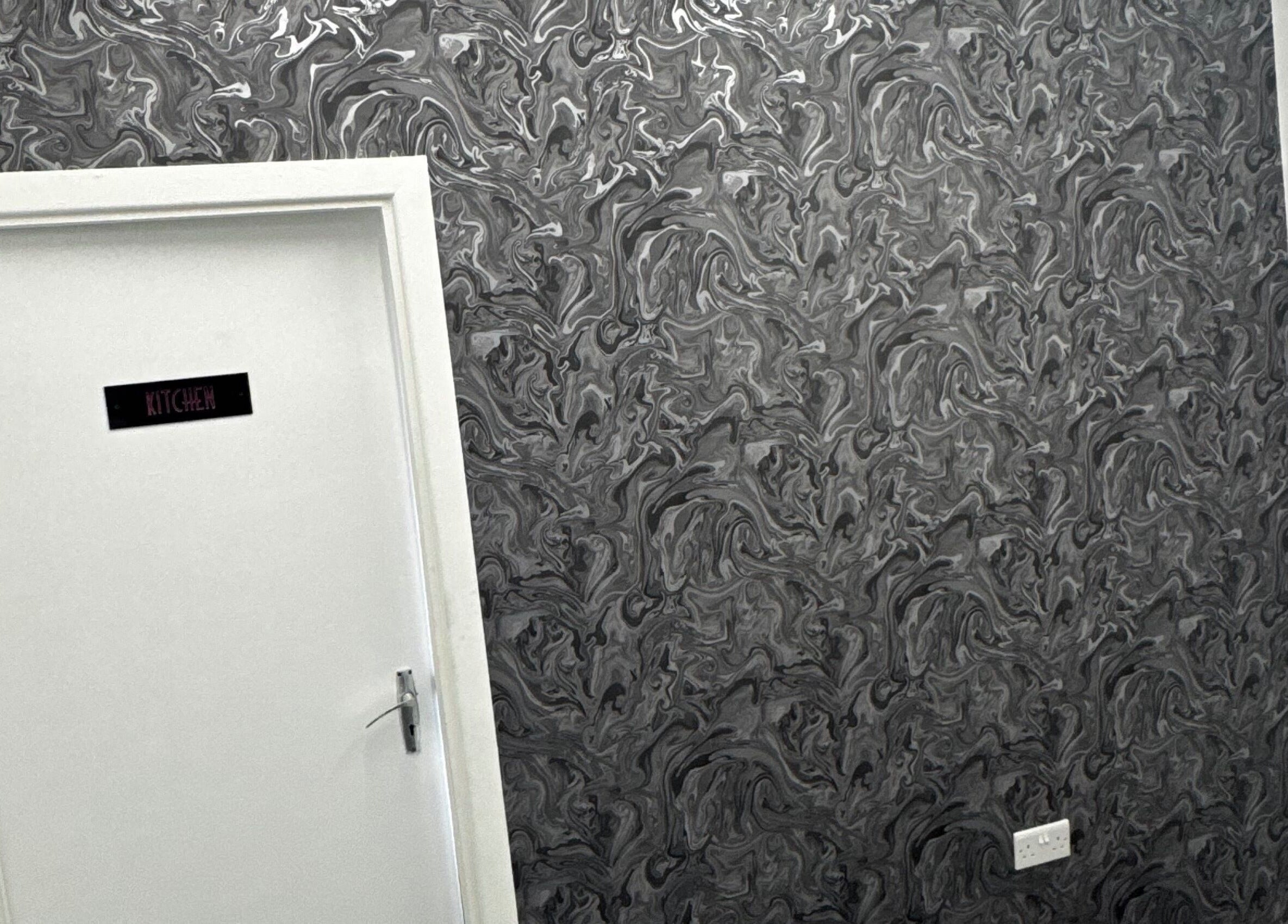 Stylish door with artistic wallpaper at Beautesuite By Erin, Dukinfield, England, GB.