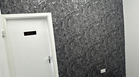 Stylish door with artistic wallpaper at Beautesuite By Erin, Dukinfield, England, GB.