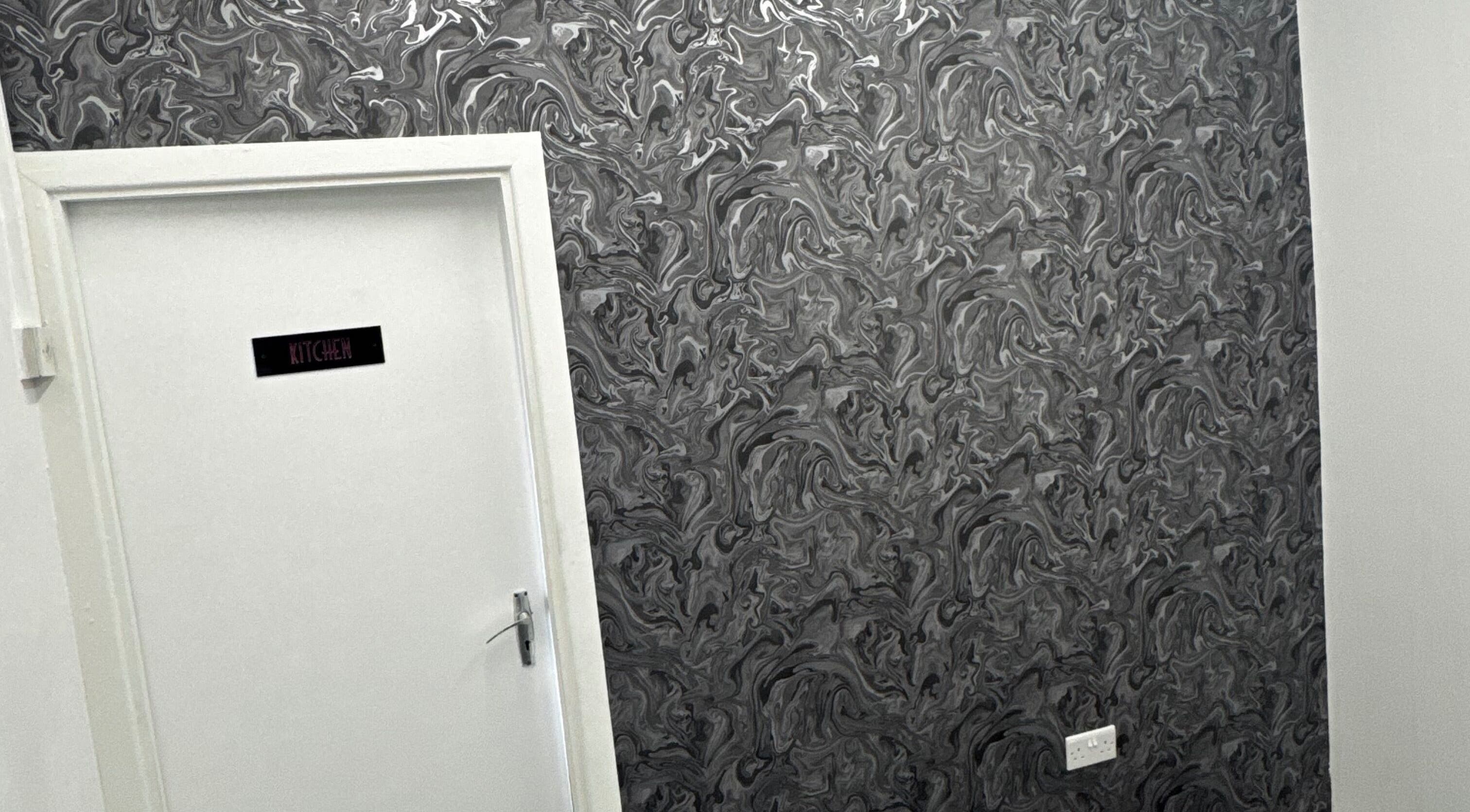 Stylish door with artistic wallpaper at Beautesuite By Erin, Dukinfield, England, GB.